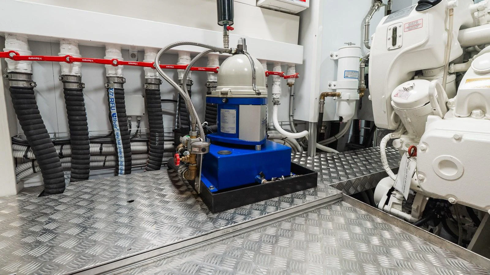 The engine room showcases well-maintained machinery and a clean, organized environment. aboard QUEEN J III Yacht for Sale