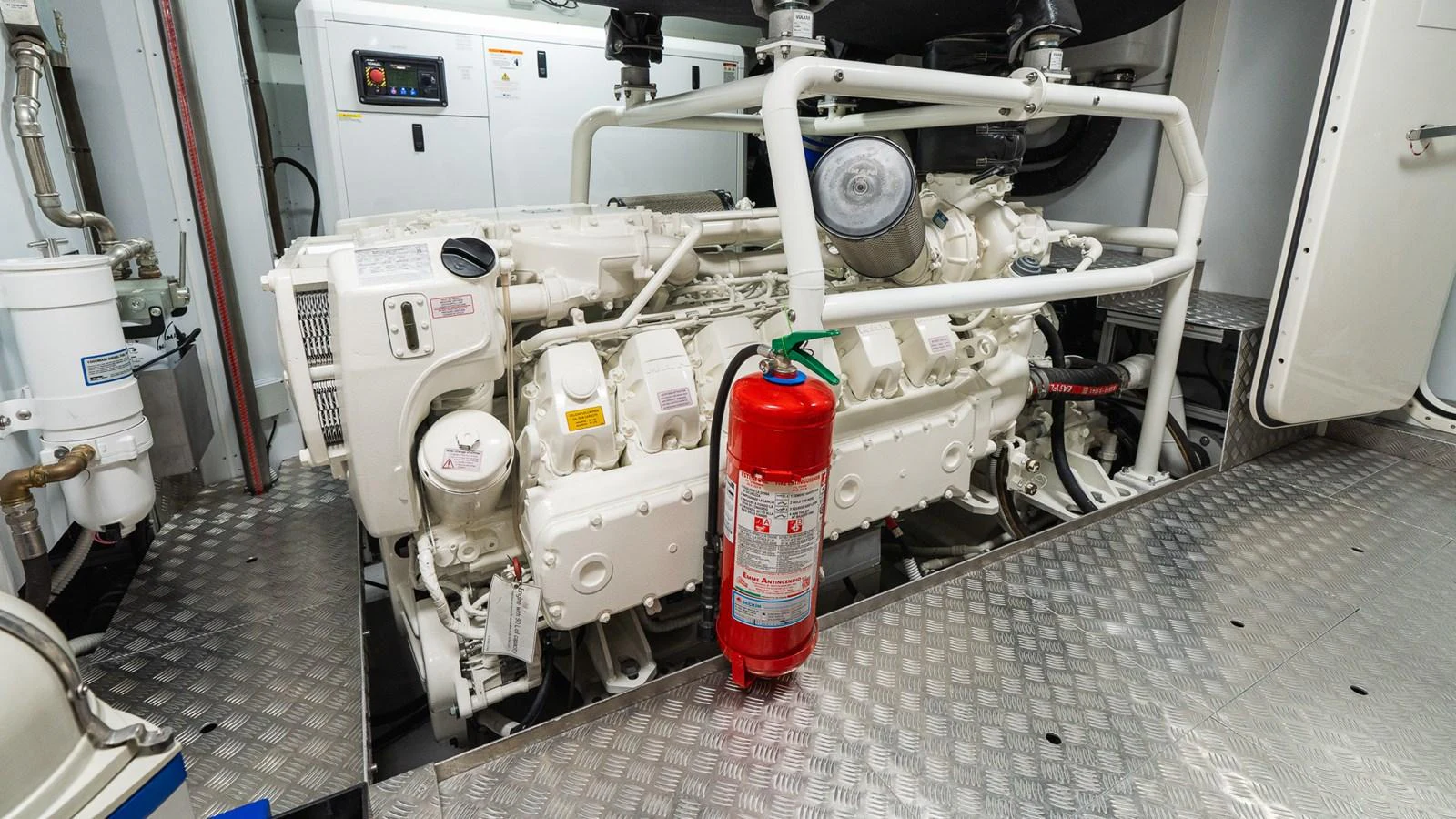 The image showcases the engine room of the yacht, featuring a well-maintained engine and safety equipment. aboard QUEEN J III Yacht for Sale