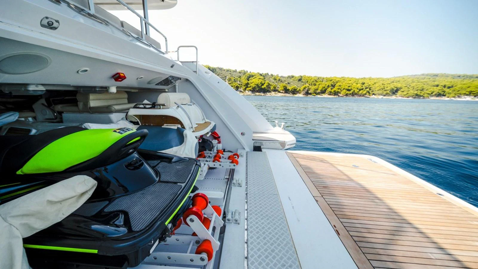 The yacht features a well-equipped toy garage with a jet ski and other water sports equipment, ready for adventure. aboard AFINA Yacht for Sale