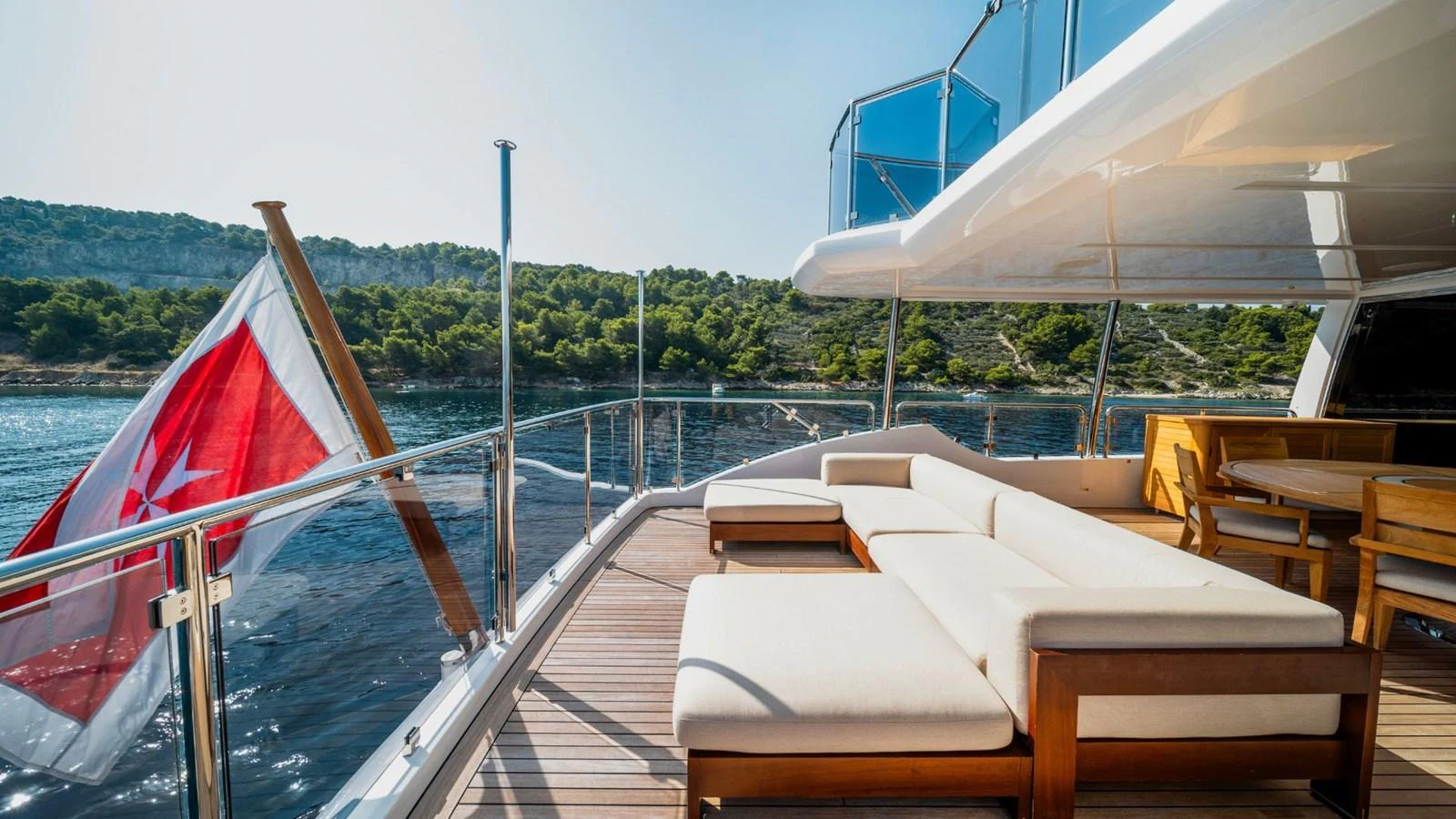 The aft deck offers a spacious lounging area with comfortable seating and scenic views. aboard AFINA Yacht for Sale