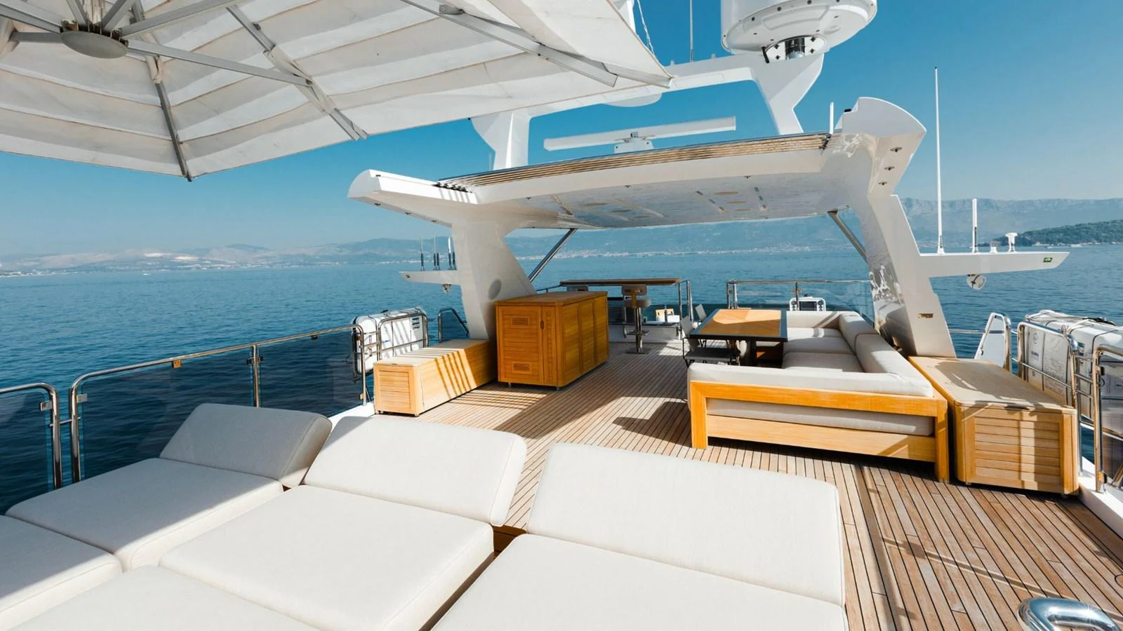 The sundeck offers ample lounging space with luxurious seating and stunning ocean views. aboard AFINA Yacht for Sale