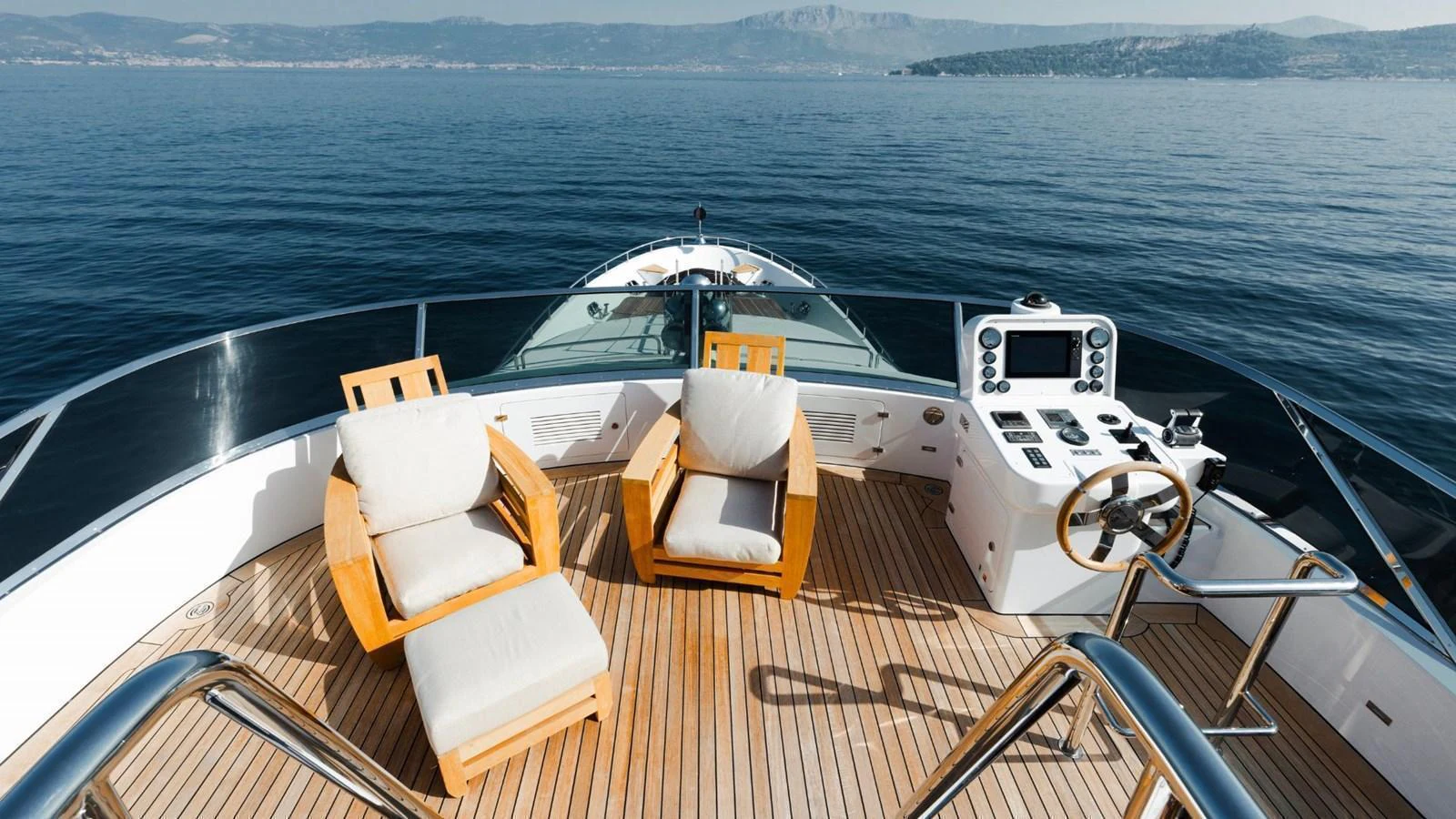 The bow of the yacht features a spacious lounging area with comfortable seating and a helm station. aboard AFINA Yacht for Sale