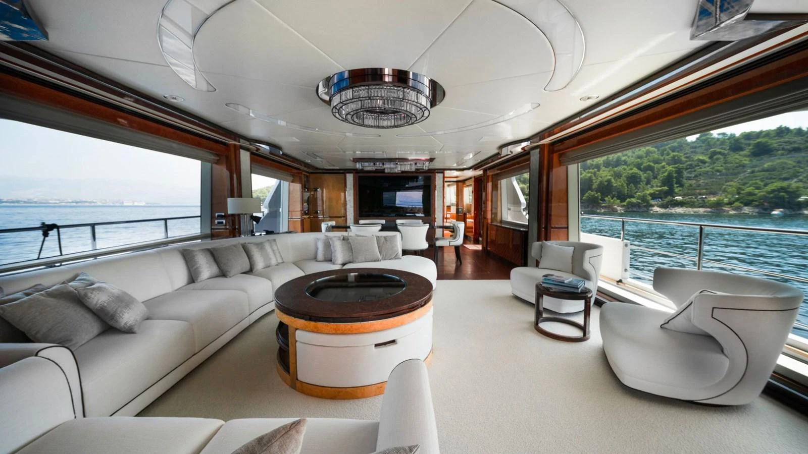 The spacious salon features luxurious seating with panoramic views of the surrounding waters. aboard AFINA Yacht for Sale