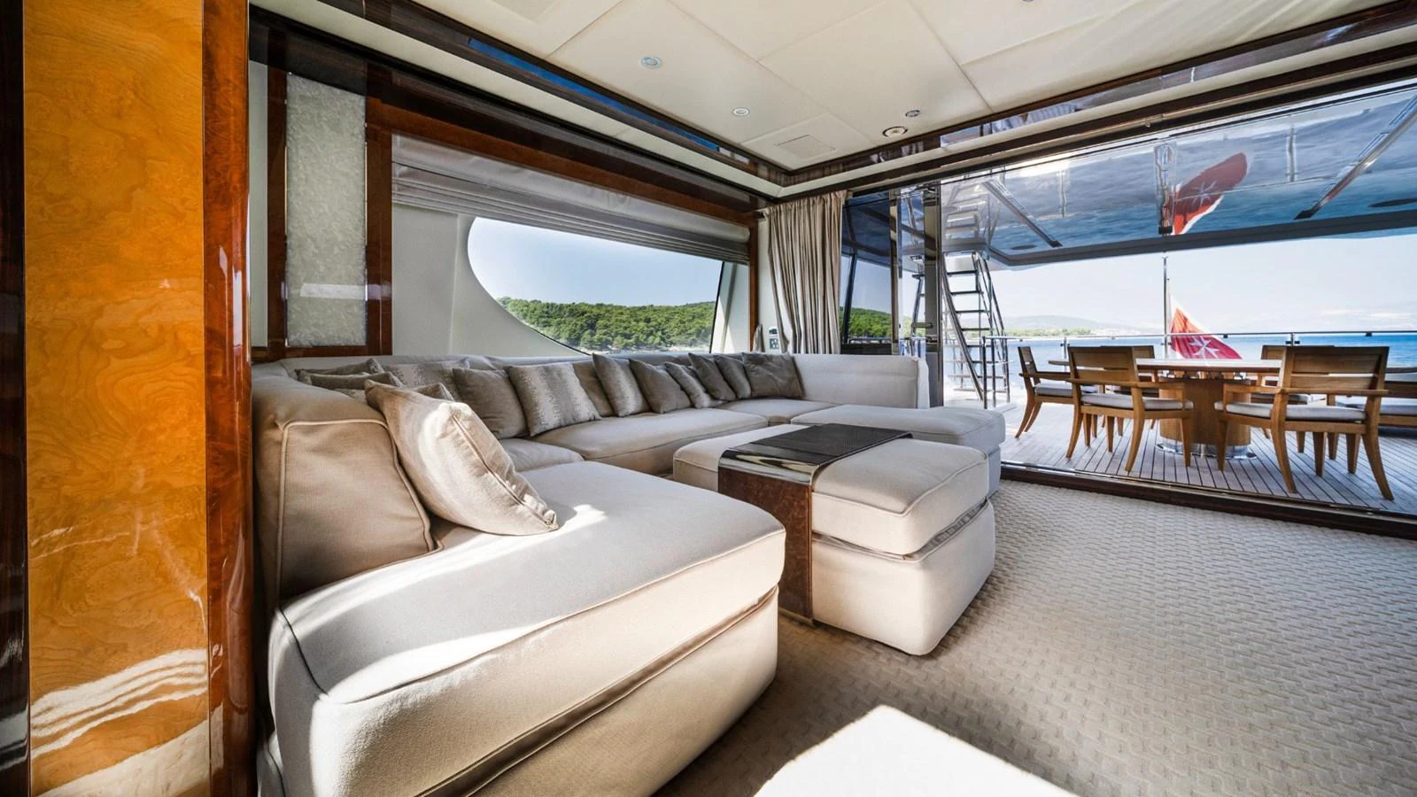The salon features a spacious and elegant seating area with a view of the aft deck. aboard AFINA Yacht for Sale