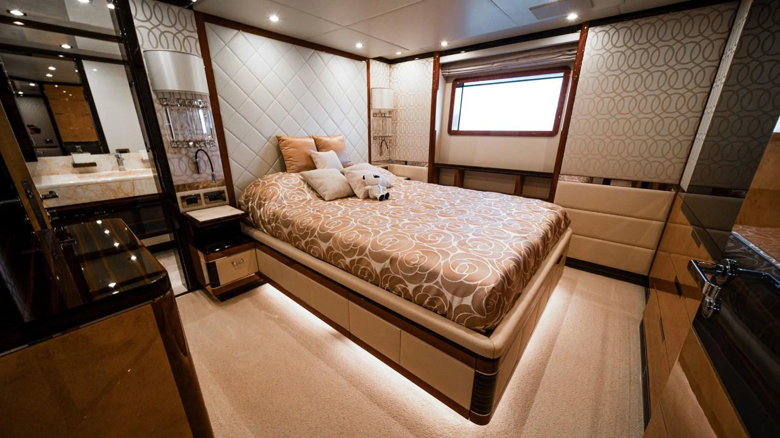 The stateroom features a luxurious bed with elegant decor and ample natural light. aboard AFINA Yacht for Sale
