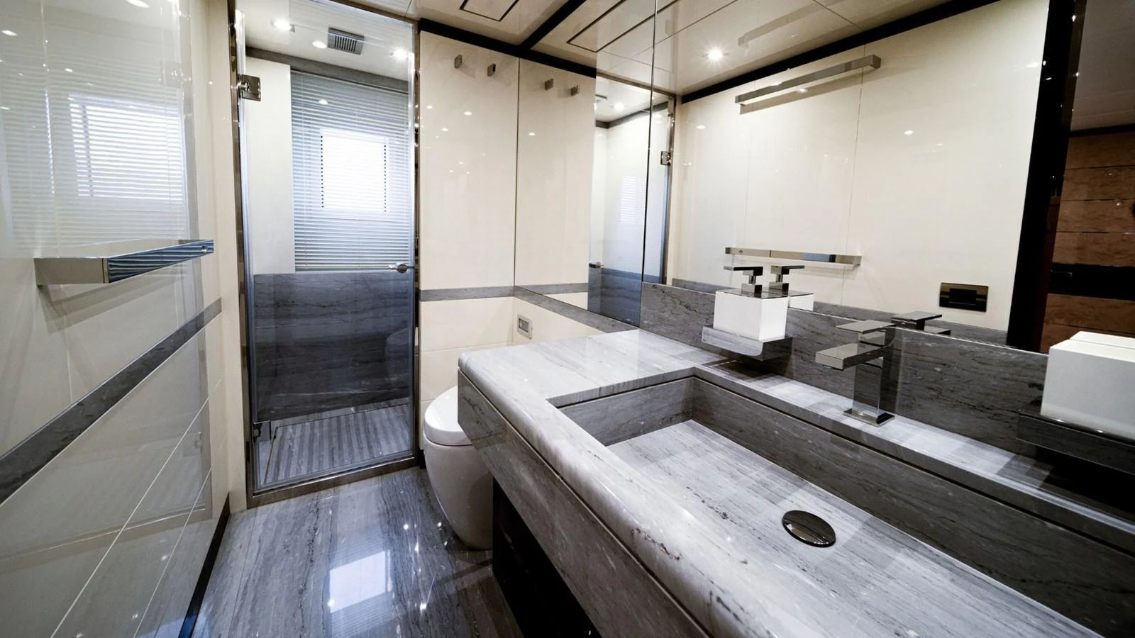 A sleek and modern bathroom with high-end fixtures and a spacious layout. aboard AFINA Yacht for Sale