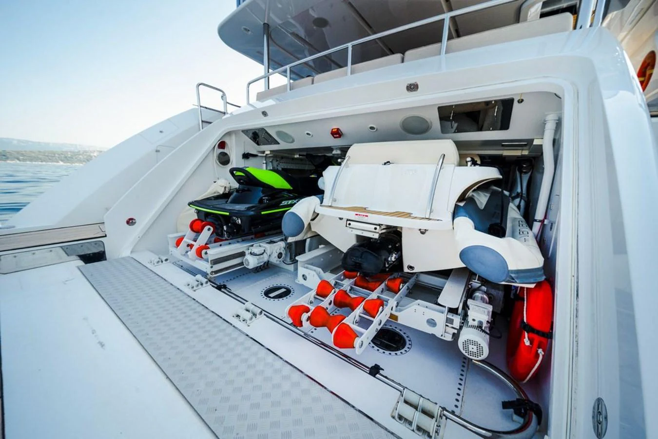 The yacht's garage is equipped with water toys and storage space, showcasing its versatility and readiness for adventure. aboard AFINA Yacht for Sale