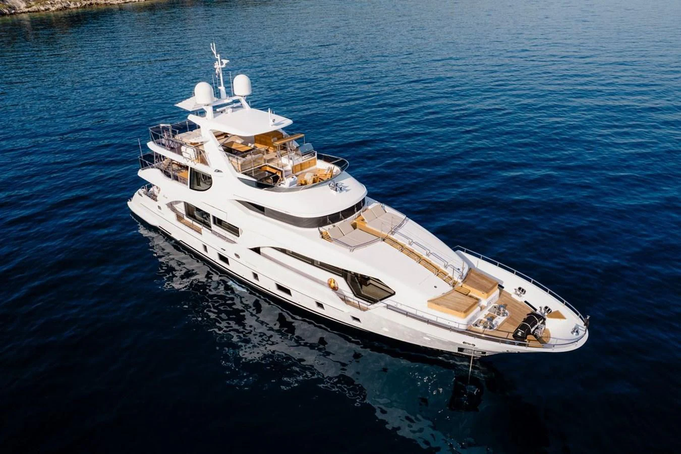 A luxurious yacht glides gracefully on calm blue waters, showcasing its elegant design and spacious decks. aboard AFINA Yacht for Sale