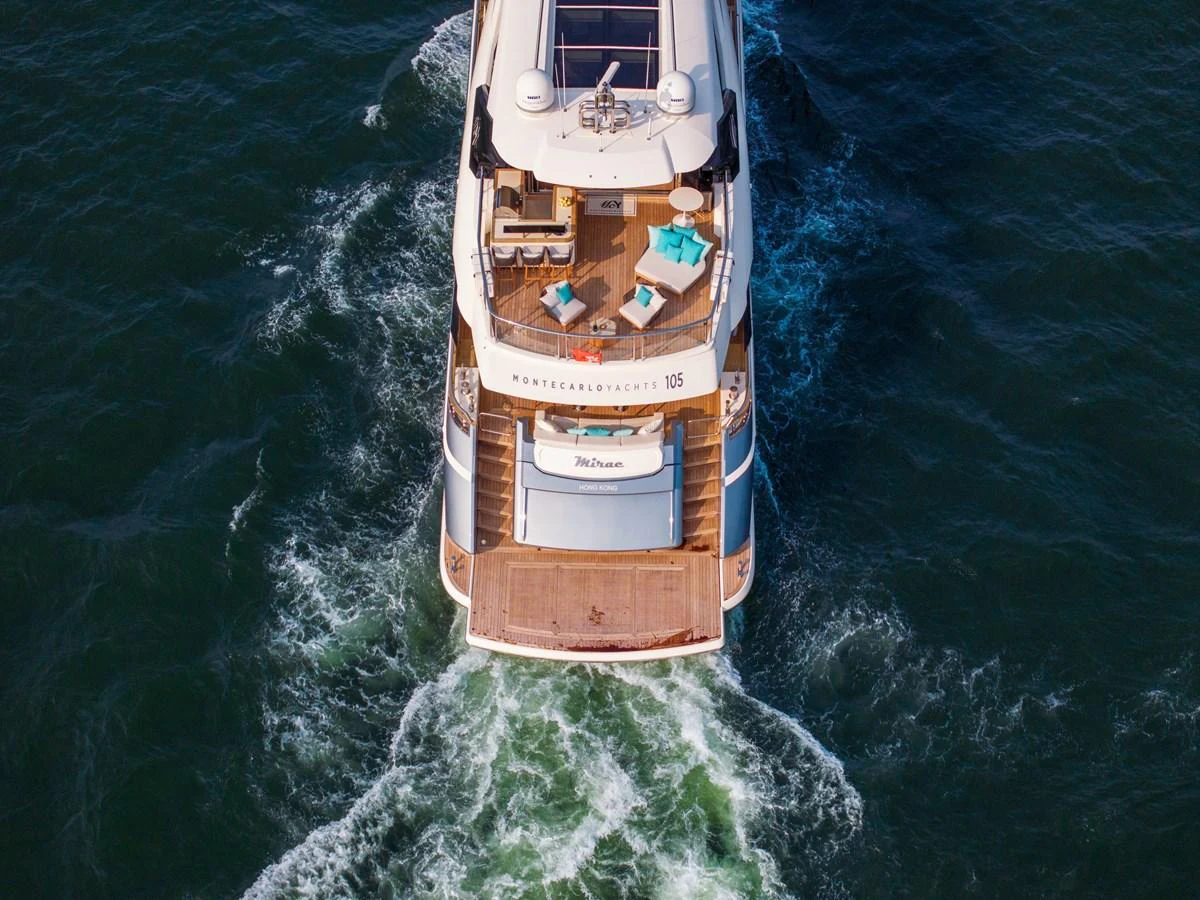 The yacht's aft deck features luxurious lounging areas with a view of the open sea. aboard MIRAE Yacht for Sale
