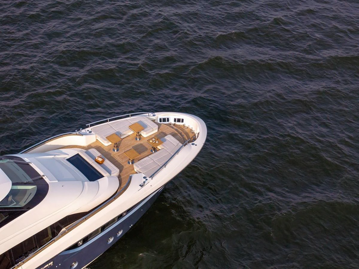 The yacht's bow features a spacious sunbathing area with luxurious seating arrangements. aboard MIRAE Yacht for Sale