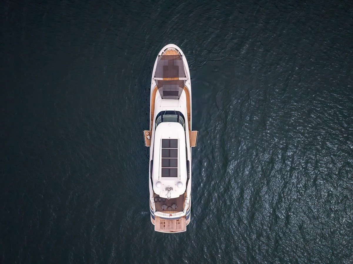 Aerial view of a sleek yacht cruising on calm waters. aboard MIRAE Yacht for Sale