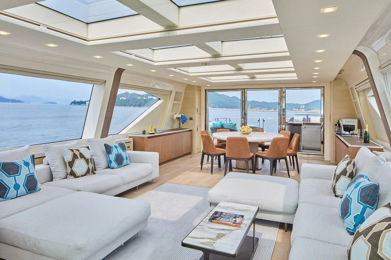 The salon offers a spacious and luxurious seating area with panoramic views and modern decor. aboard MIRAE Yacht for Sale