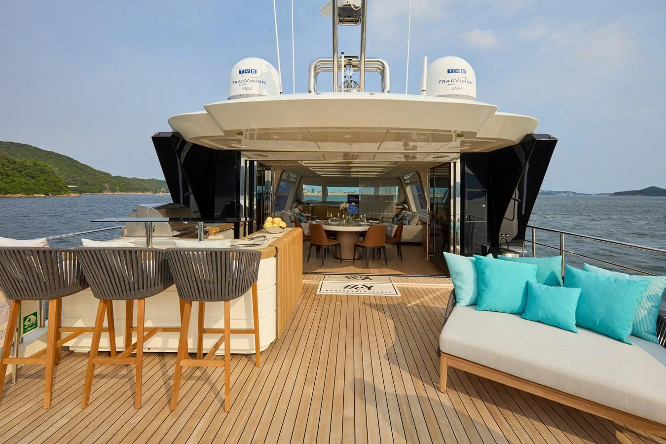 The aft deck features a spacious seating area with a bar and lounge chairs, perfect for relaxation and entertaining. aboard MIRAE Yacht for Sale