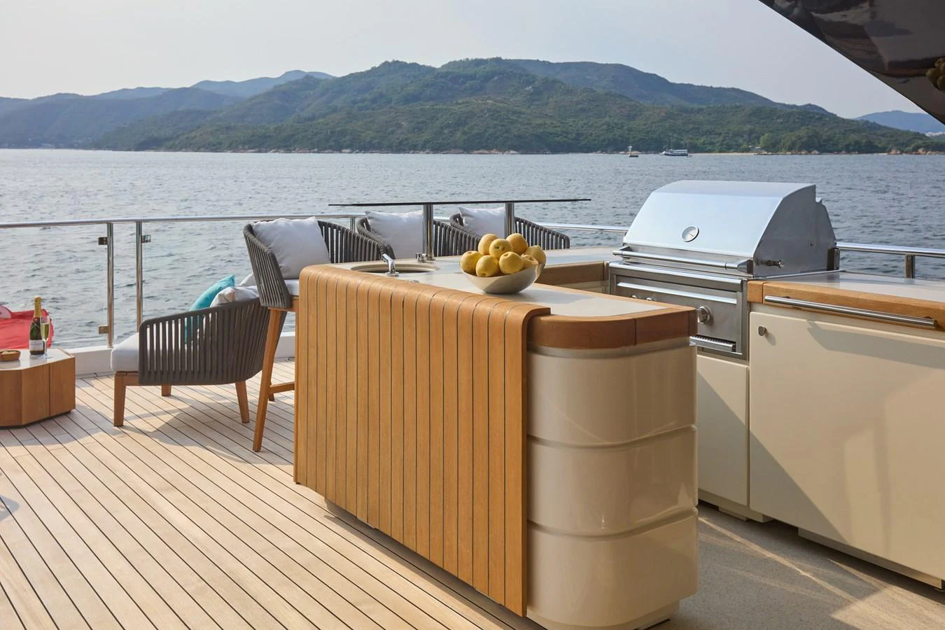The aft deck features a stylish outdoor kitchen with a grill and comfortable seating, perfect for alfresco dining. aboard MIRAE Yacht for Sale