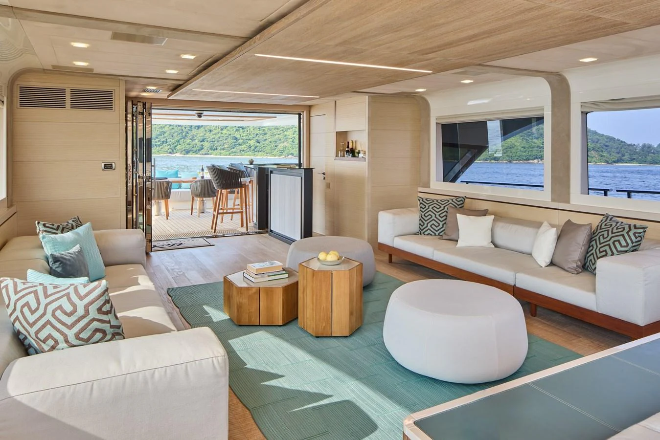 The salon offers a spacious and modern living area with large windows providing stunning views of the sea. aboard MIRAE Yacht for Sale
