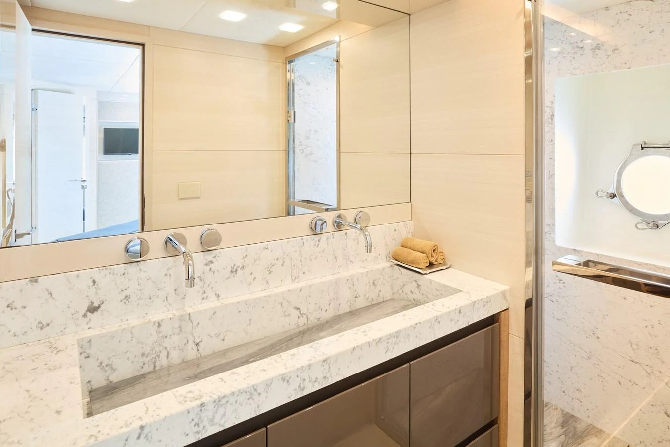 The yacht's bathroom features a sleek, modern design with a marble countertop and ample lighting. aboard MIRAE Yacht for Sale