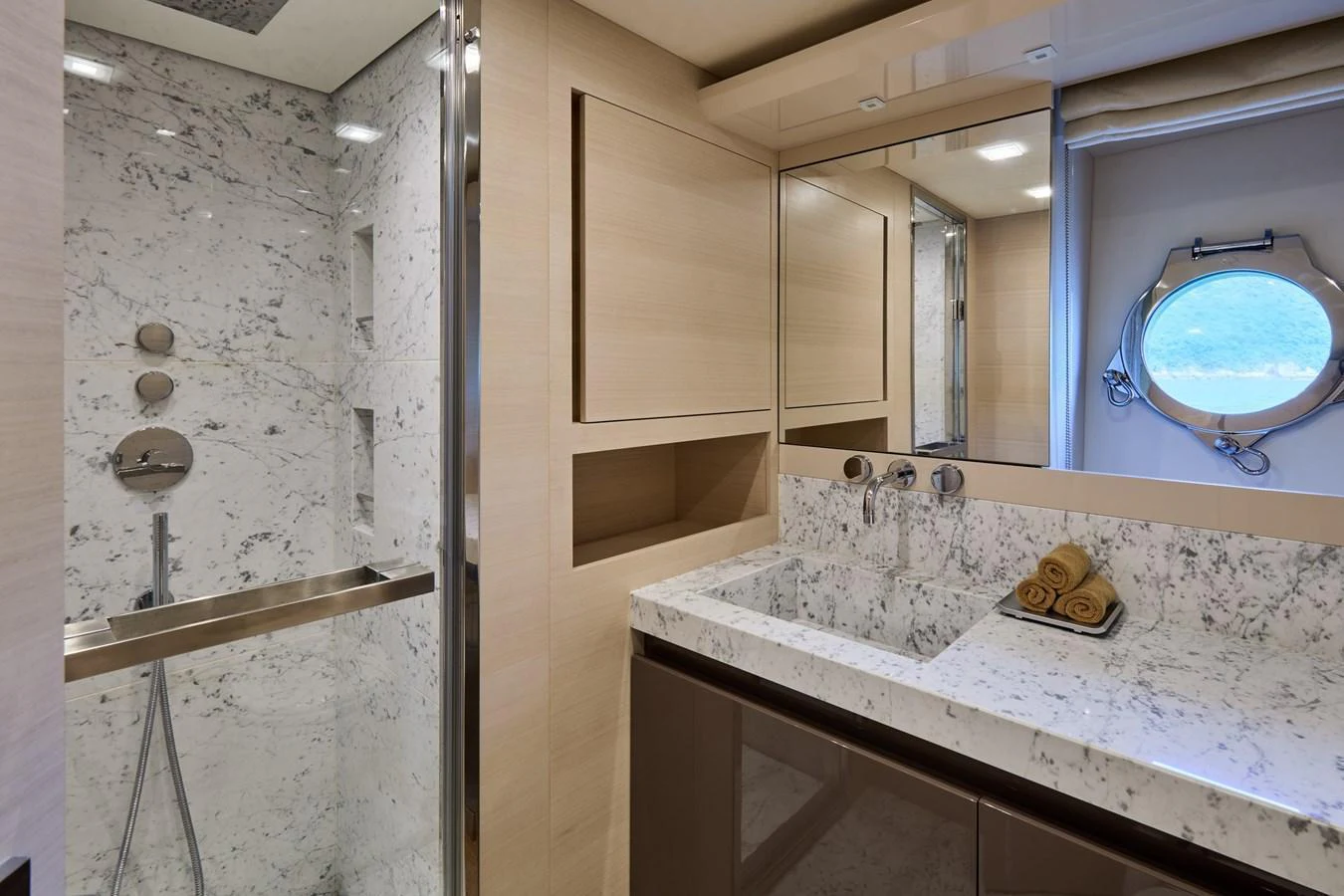 The yacht's bathroom features a luxurious marble sink and shower area with modern fixtures. aboard MIRAE Yacht for Sale