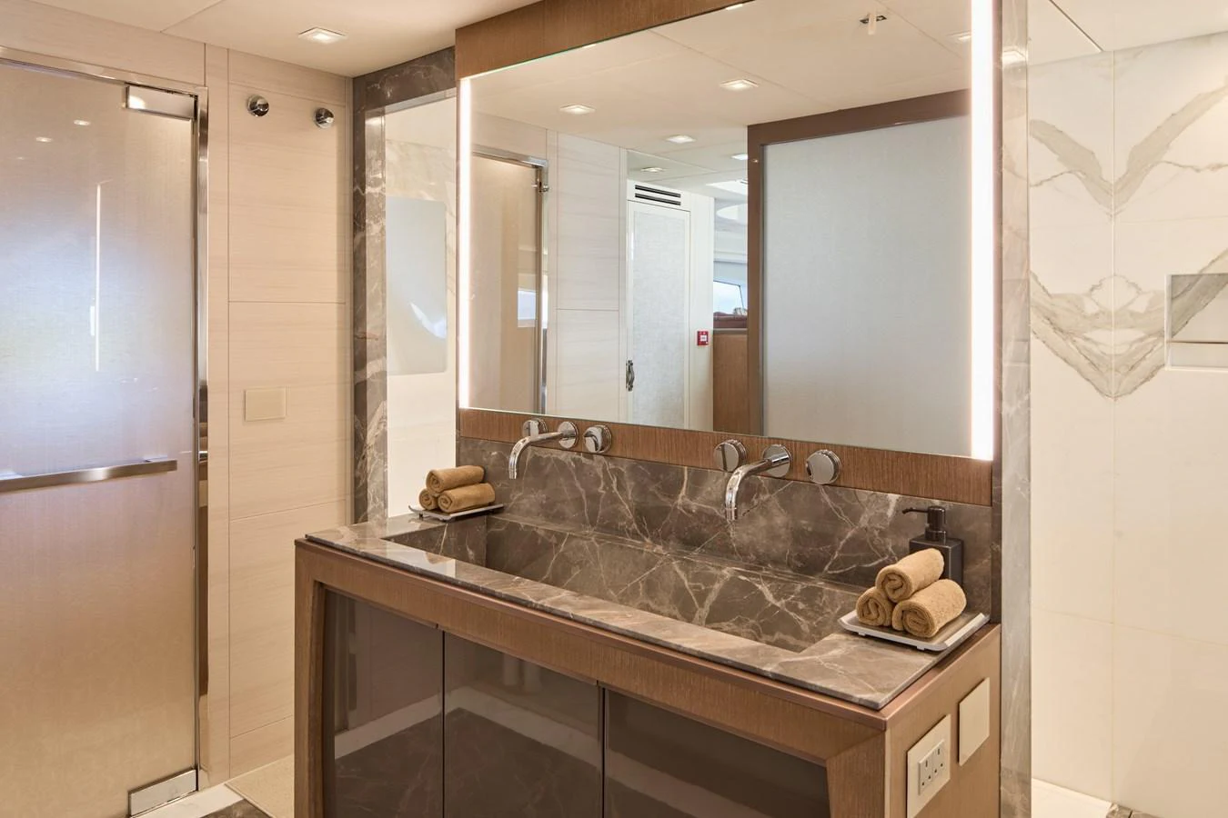 The yacht's bathroom features a luxurious double sink with elegant marble countertops and modern fixtures. aboard MIRAE Yacht for Sale