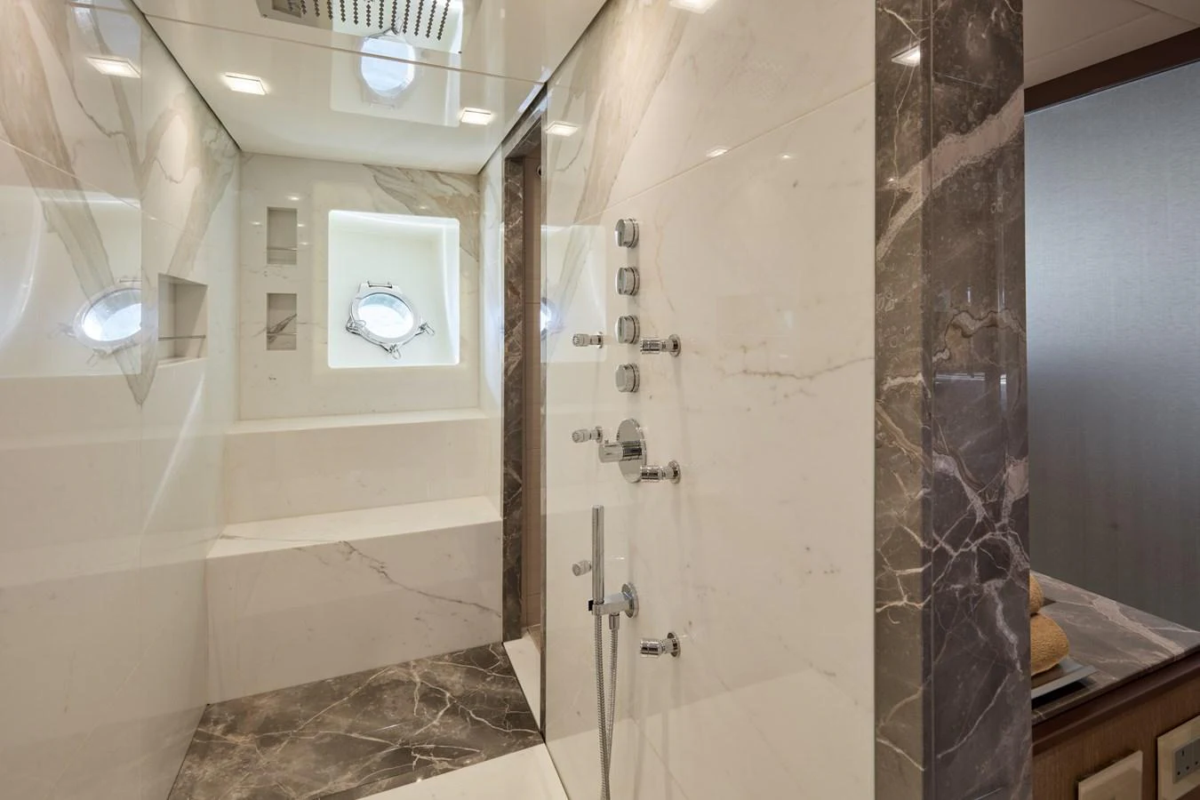 The yacht's bathroom features luxurious marble finishes and a spacious shower area. aboard MIRAE Yacht for Sale