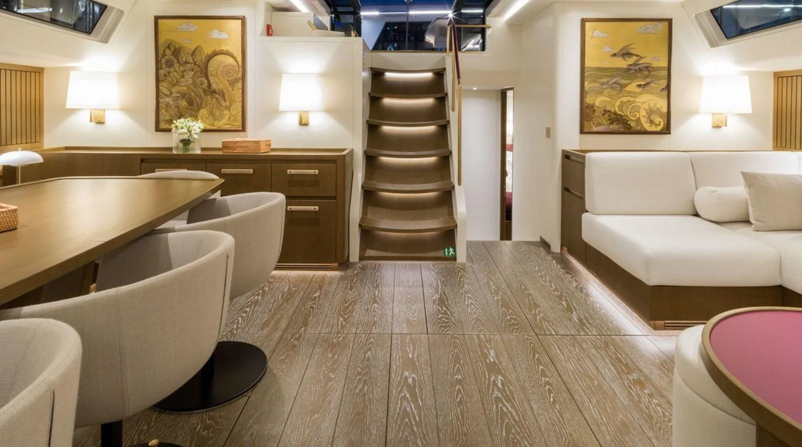 The salon features elegant decor with comfortable seating and refined wooden accents. aboard FANCY Yacht for Sale