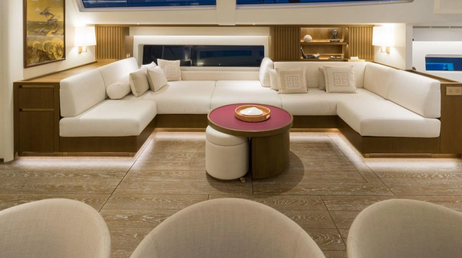 The salon features a spacious and elegant seating area with plush white sofas and a stylish coffee table. aboard FANCY Yacht for Sale