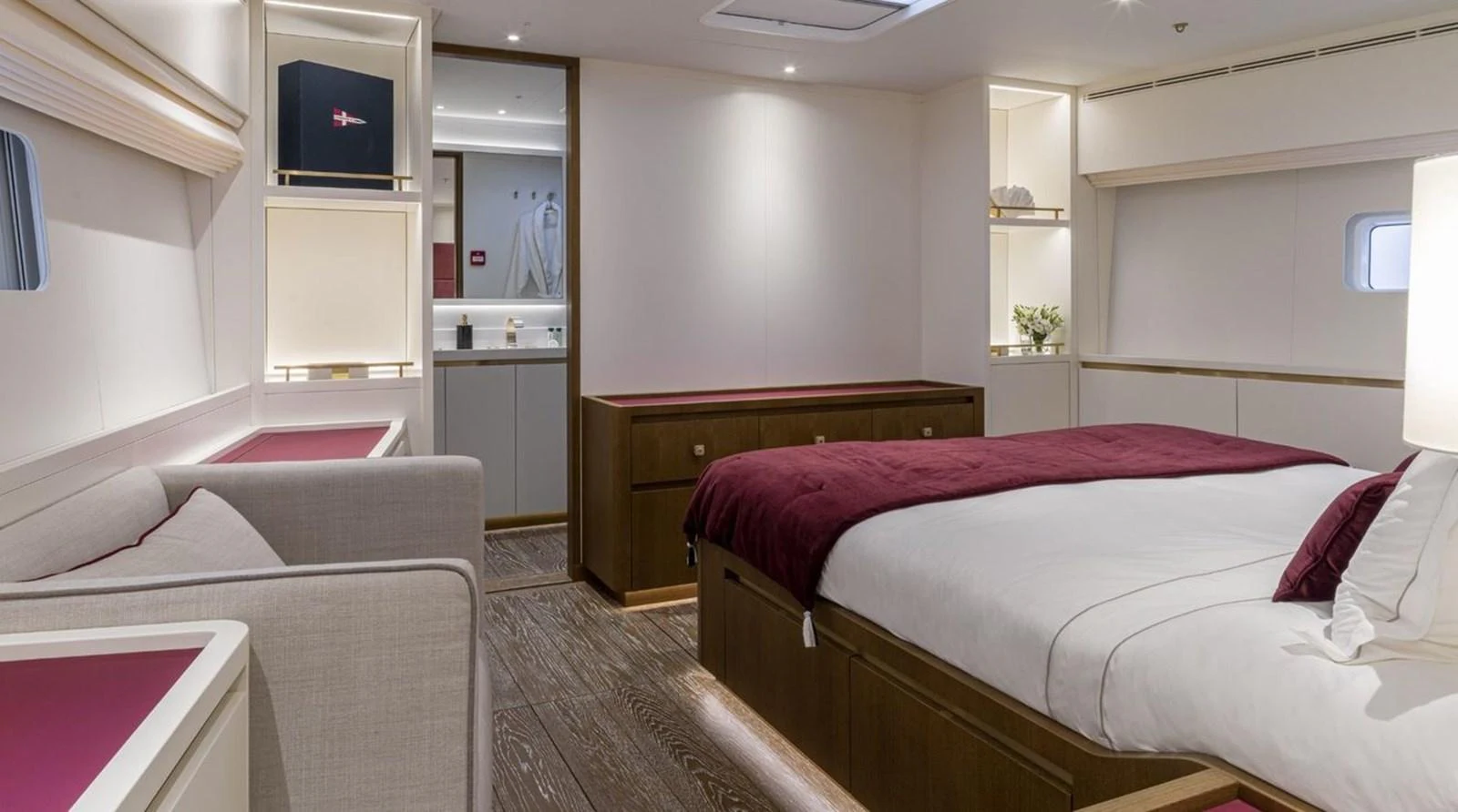 The stateroom features a luxurious bed with elegant furnishings and ambient lighting. aboard FANCY Yacht for Sale
