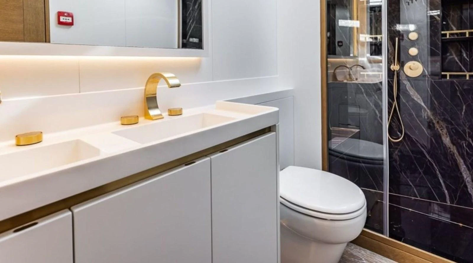 A luxurious yacht bathroom featuring a double sink, modern fixtures, and a spacious shower. aboard FANCY Yacht for Sale