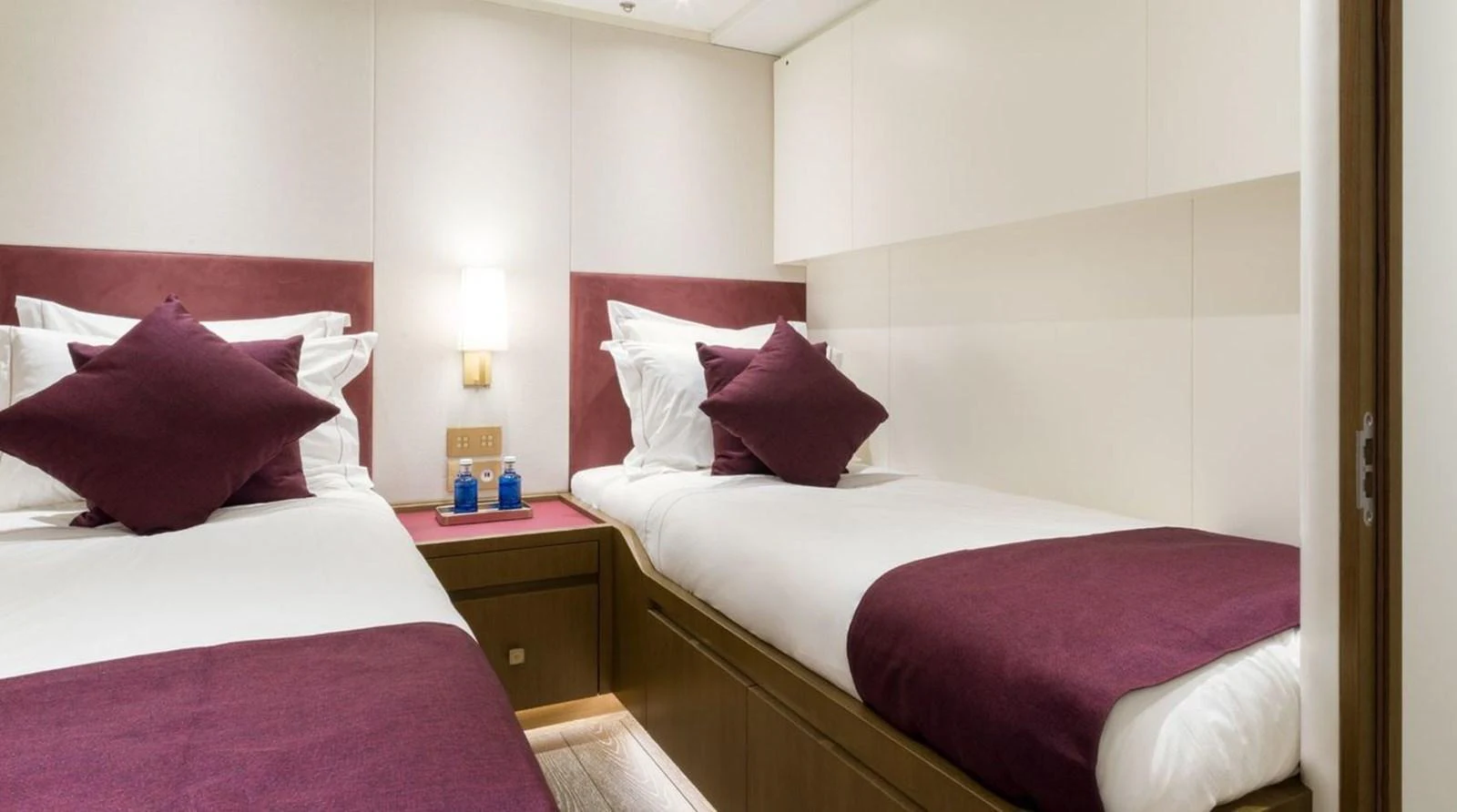 The twin stateroom features two single beds with plush bedding and modern decor. aboard FANCY Yacht for Sale