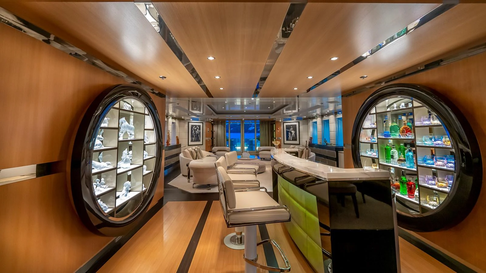 The yacht's lounge area features luxurious seating and elegant display cabinets, creating a sophisticated ambiance. aboard SCOTT FREE Yacht for Sale