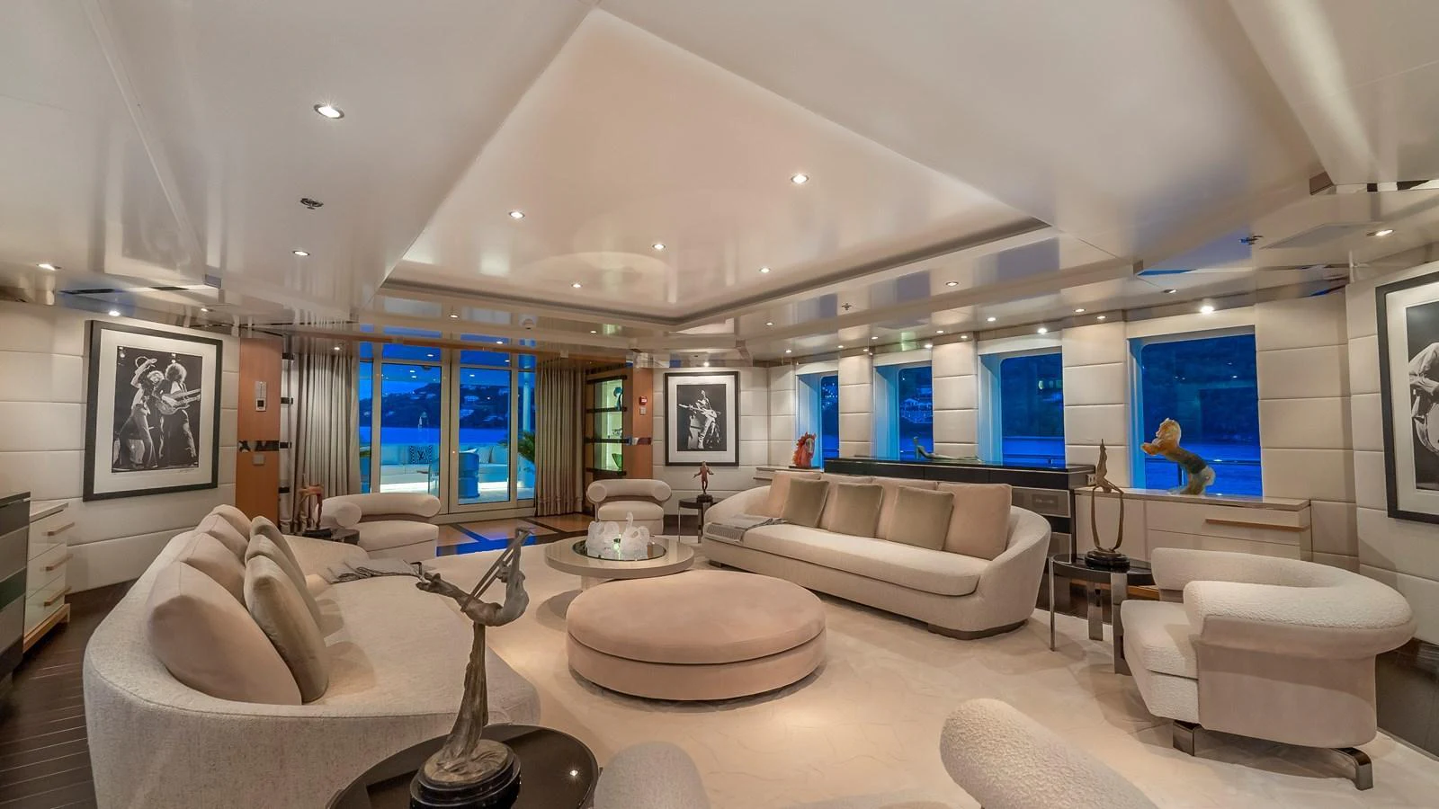 The luxurious salon features elegant seating and modern decor with large windows offering stunning views. aboard SCOTT FREE Yacht for Sale