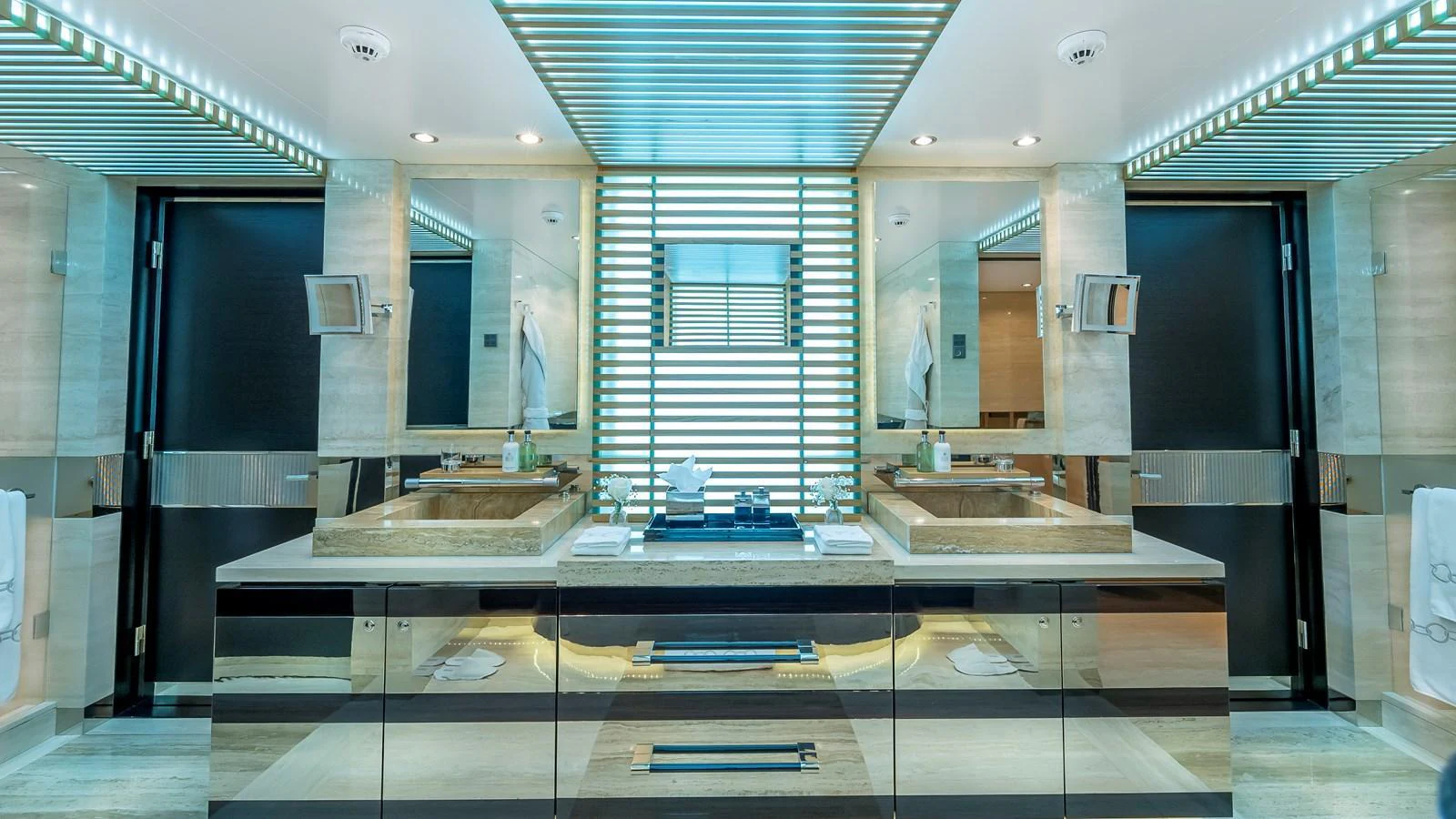 The luxurious bathroom features dual sinks, modern fixtures, and elegant lighting. aboard SCOTT FREE Yacht for Sale