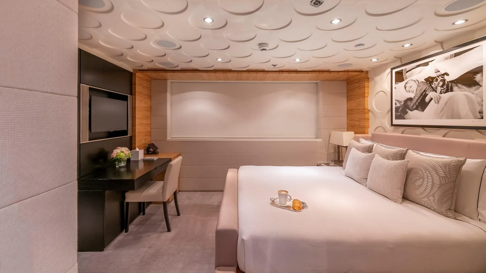 A luxurious stateroom featuring a large bed, a desk area, and elegant decor. aboard SCOTT FREE Yacht for Sale