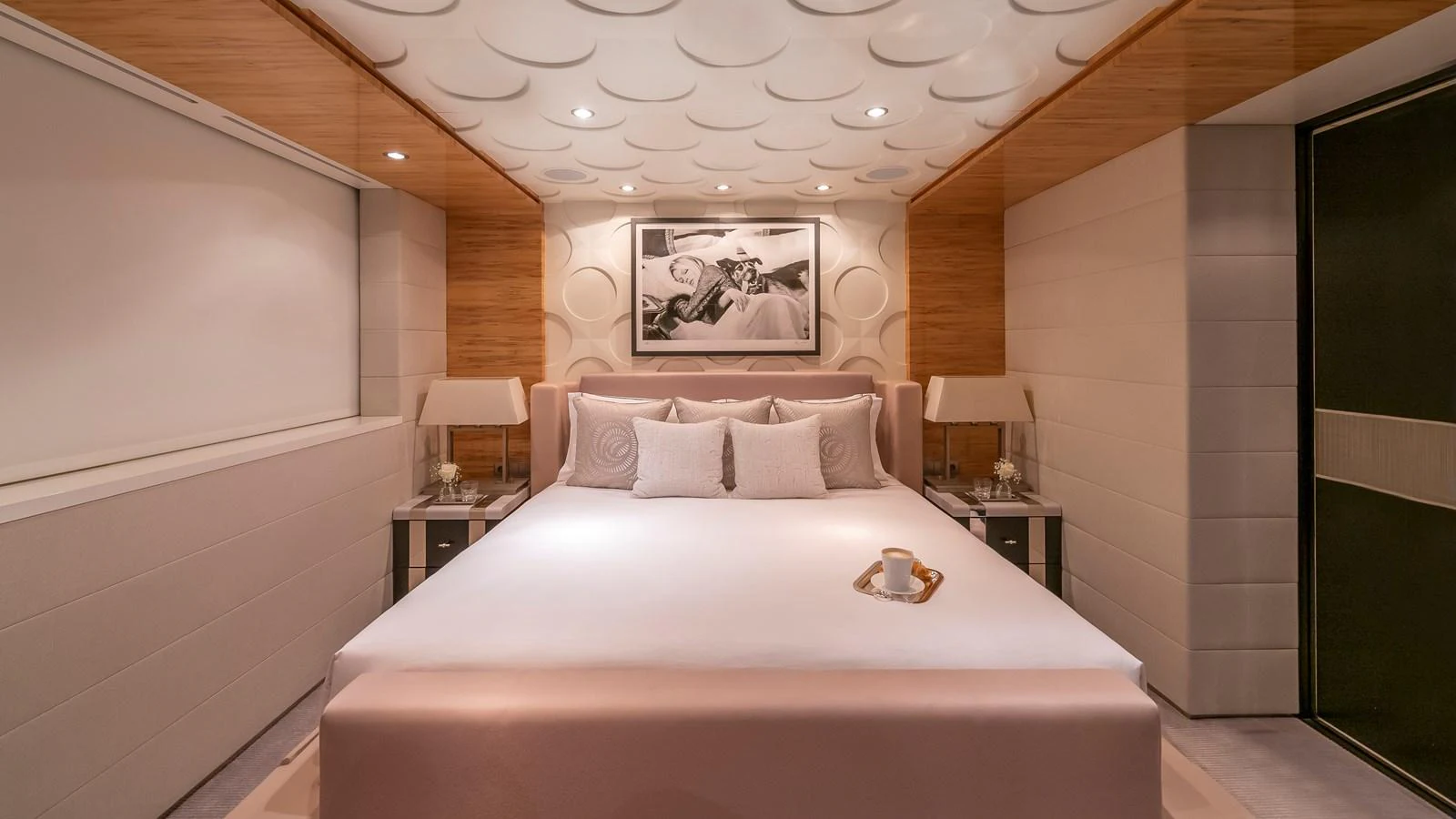 The stateroom features a luxurious bed with elegant decor and ambient lighting. aboard SCOTT FREE Yacht for Sale