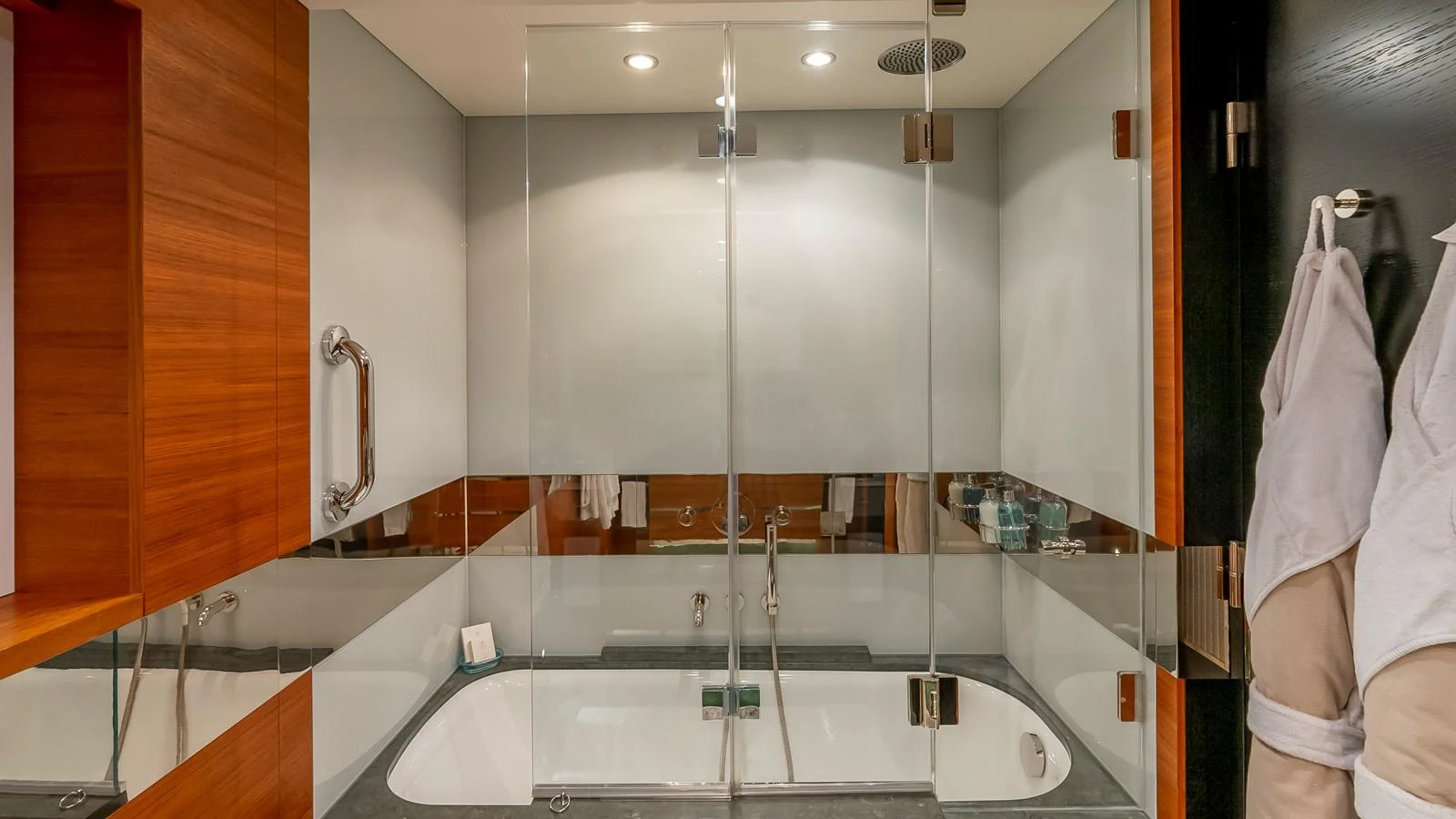The yacht's bathroom features a sleek, modern design with a glass-enclosed shower and luxurious fixtures. aboard SCOTT FREE Yacht for Sale
