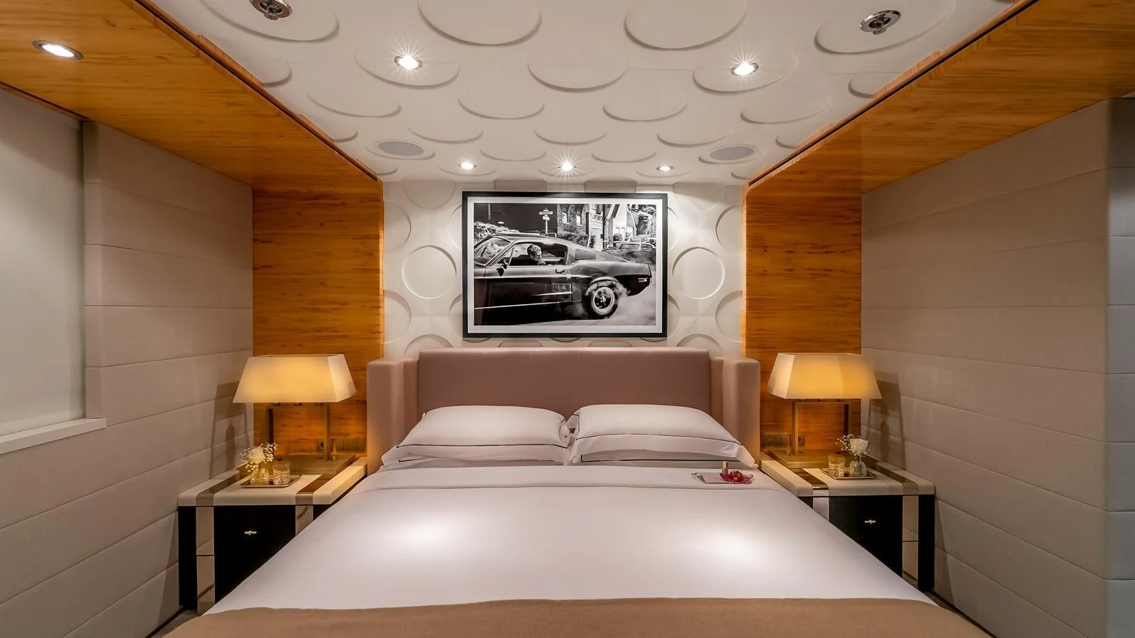 The stateroom features a luxurious bed with elegant lighting and modern decor. aboard SCOTT FREE Yacht for Sale