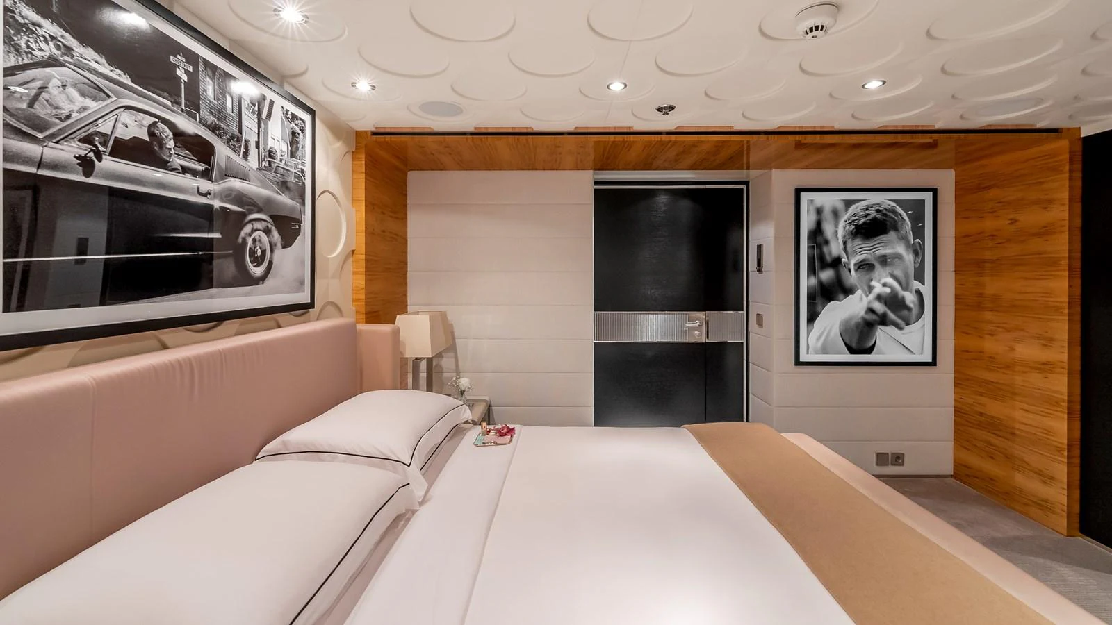 The stateroom features a luxurious bed with elegant decor and modern artwork. aboard SCOTT FREE Yacht for Sale