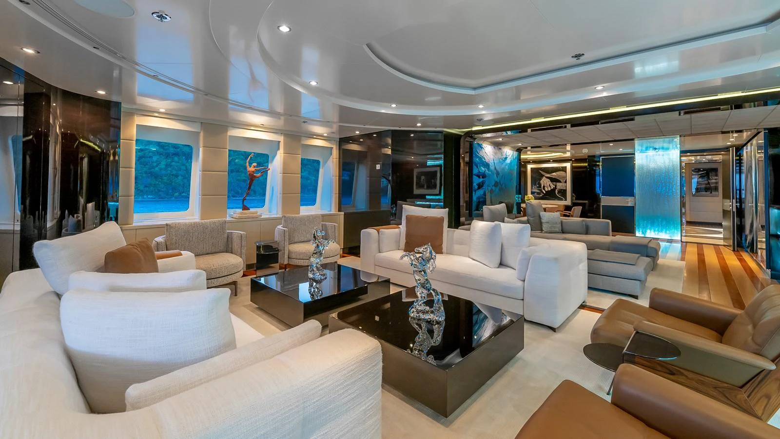 The salon features luxurious seating and modern decor with ample natural light. aboard SCOTT FREE Yacht for Sale