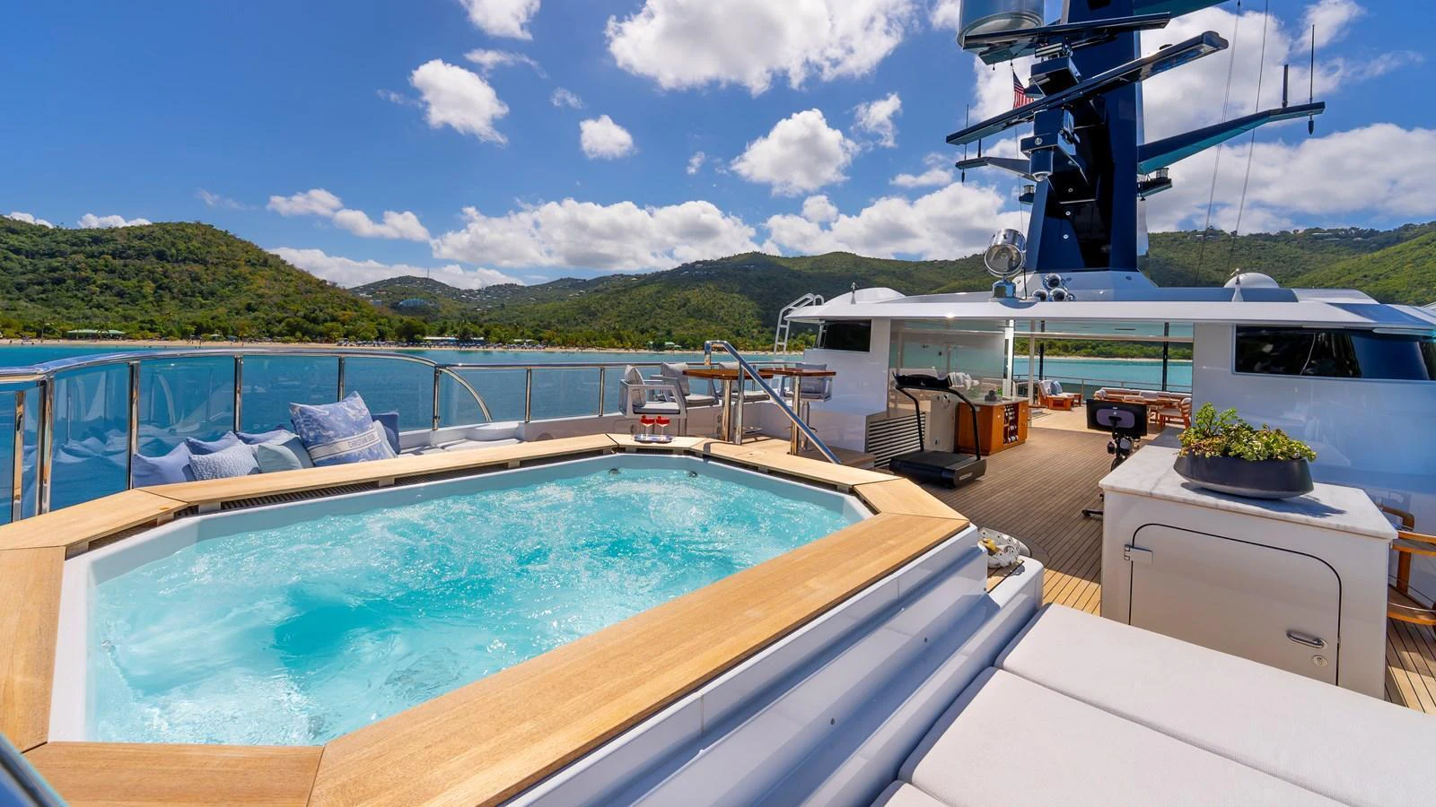 The sundeck features a luxurious hot tub with stunning views of the surrounding waters and landscape. aboard SCOTT FREE Yacht for Sale