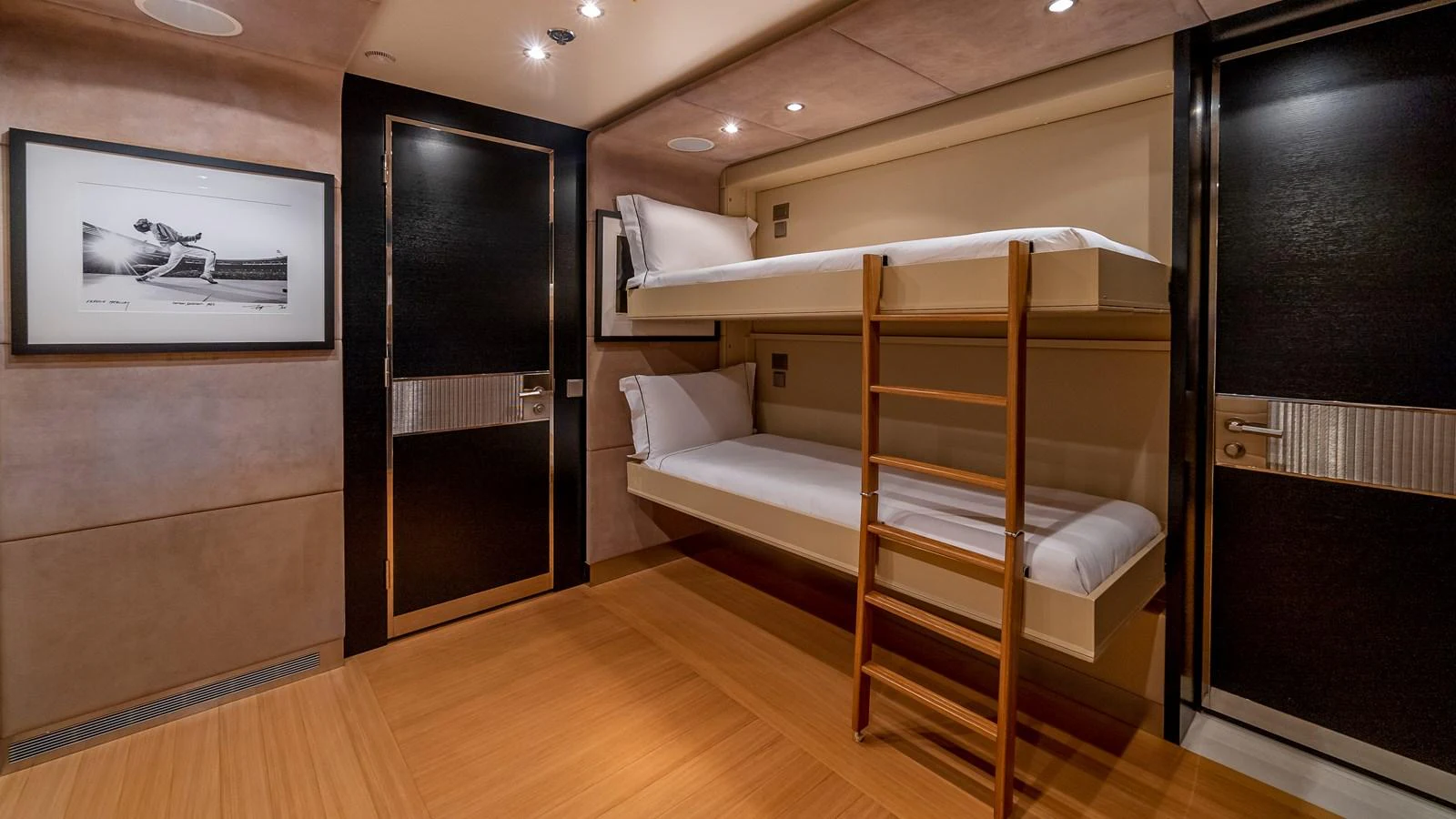 A cozy guest cabin with bunk beds and modern decor. aboard SCOTT FREE Yacht for Sale