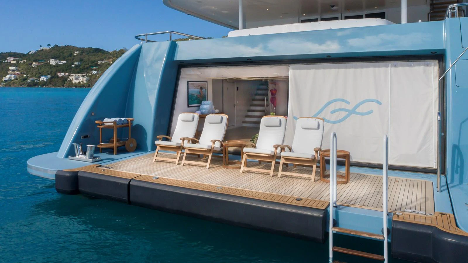 The yacht's beach club offers a serene space for relaxation with comfortable lounge chairs and easy access to the water. aboard SCOTT FREE Yacht for Sale