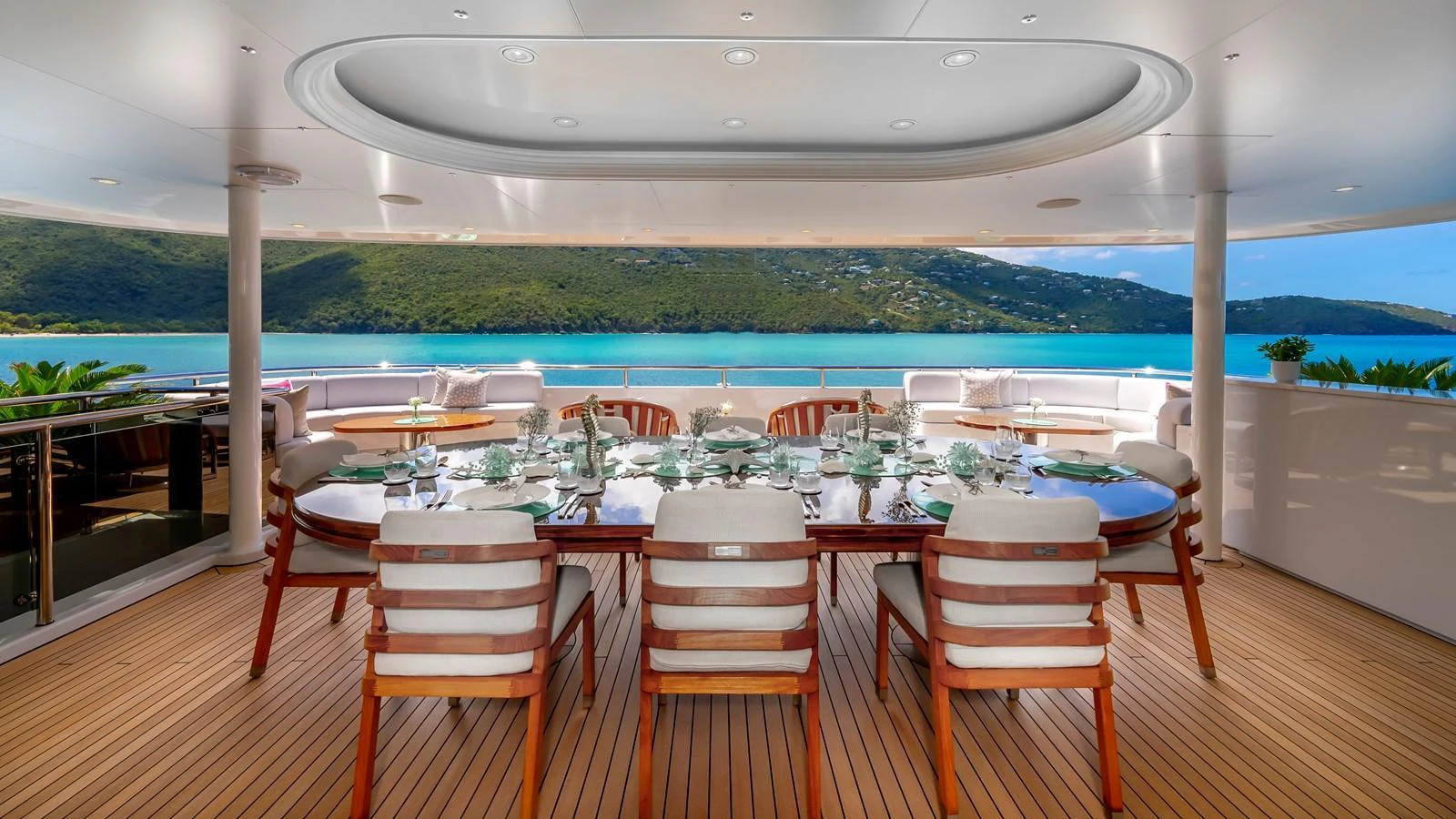 The aft deck features an elegant dining area with a stunning view of the surrounding waters. aboard SCOTT FREE Yacht for Sale