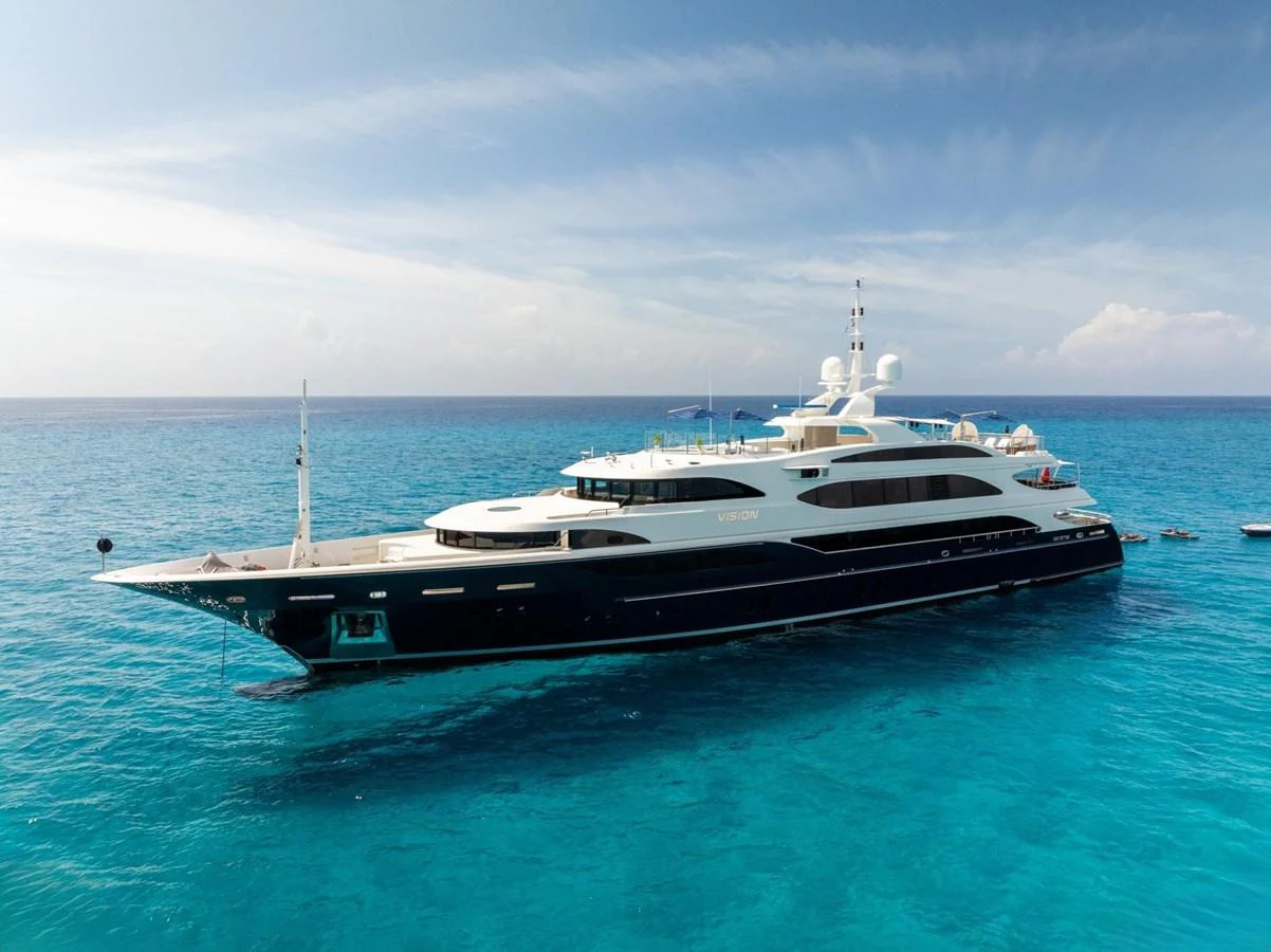 A sleek and luxurious yacht glides gracefully on the tranquil blue waters. aboard VISION Yacht for Sale