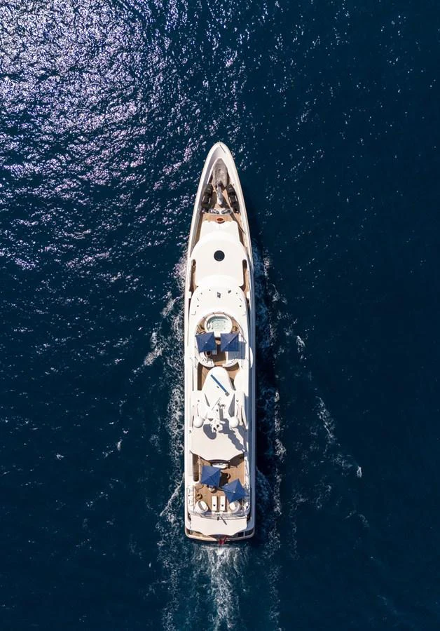 Aerial view of a luxurious yacht cruising through deep blue waters. aboard VISION Yacht for Sale