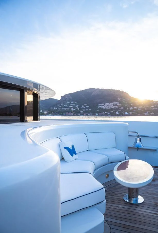 The sundeck features a comfortable seating area with a scenic view of the coastline. aboard VISION Yacht for Sale