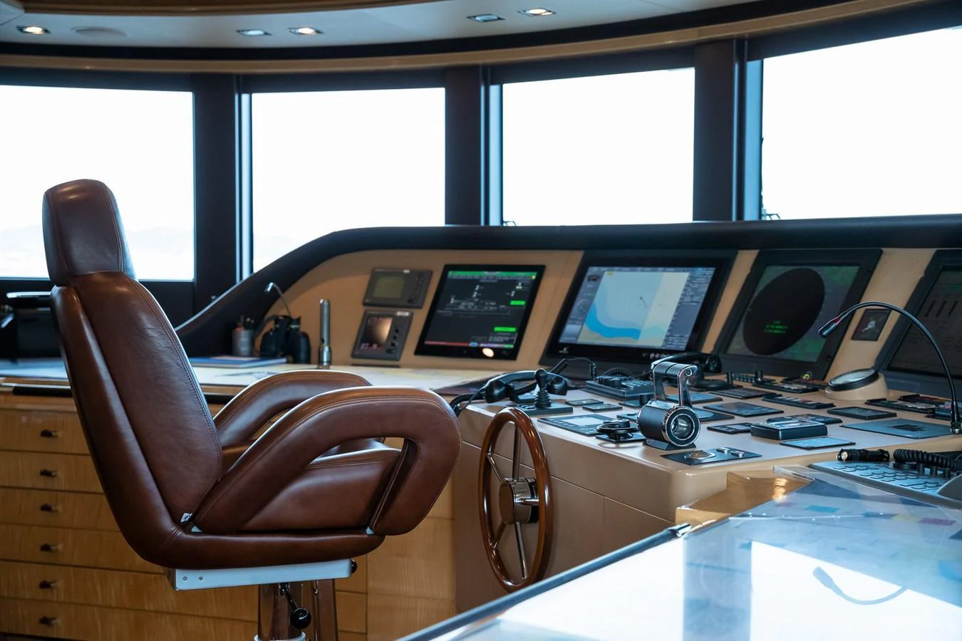 The helm station features a luxurious leather captain's chair and state-of-the-art navigation equipment. aboard VISION Yacht for Sale