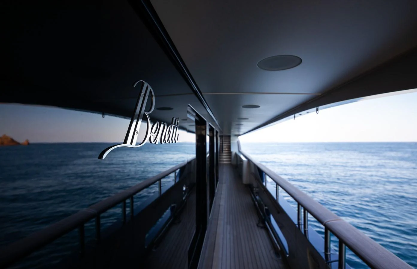 A sleek side deck with a polished reflection of the yacht's name on the glass. aboard VISION Yacht for Sale