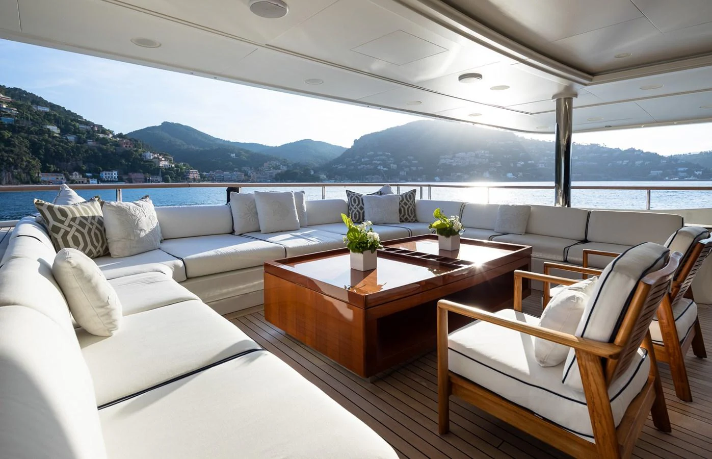 The aft deck features a spacious and elegant seating area with plush cushions and a stunning view of the surrounding landscape. aboard VISION Yacht for Sale