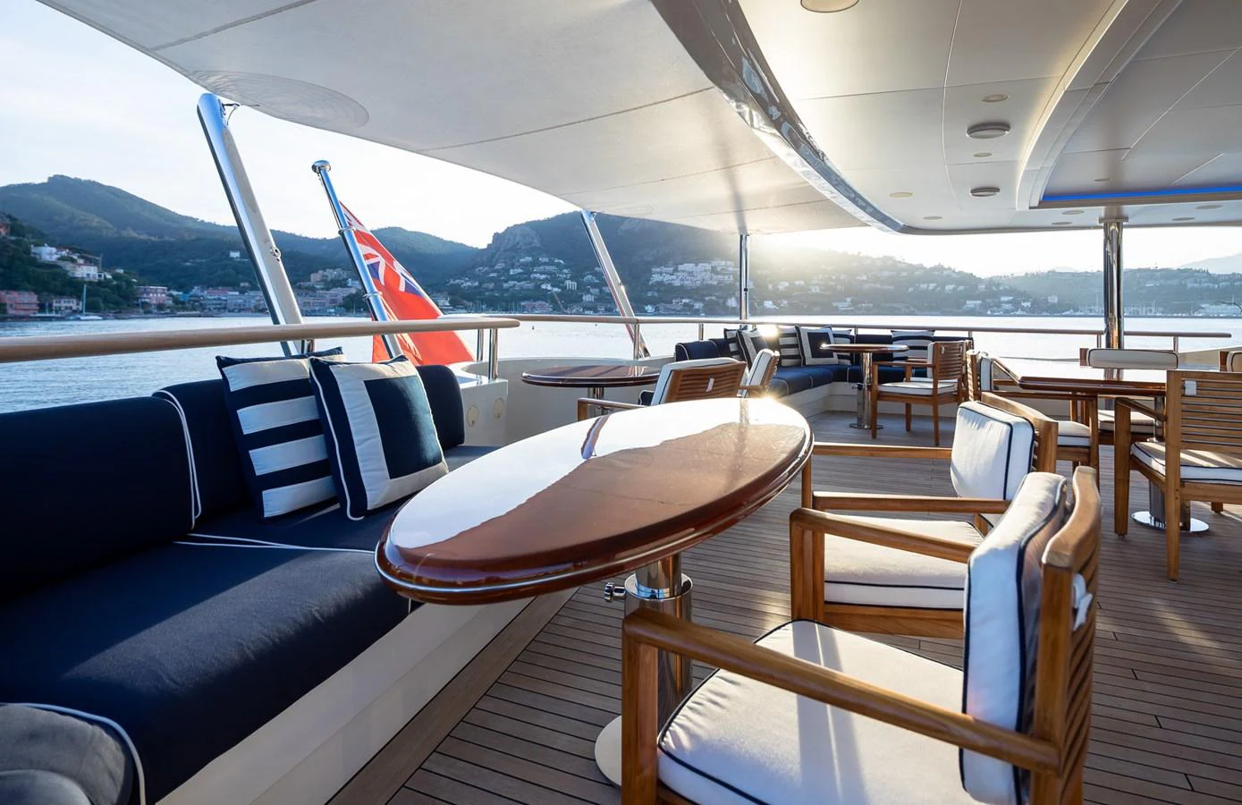 The aft deck offers a spacious and elegant outdoor seating area with stunning views. aboard VISION Yacht for Sale