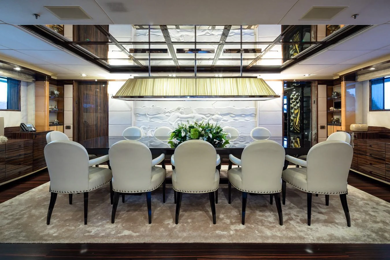 The elegant dining area features a large table surrounded by plush chairs, perfect for sophisticated gatherings. aboard VISION Yacht for Sale