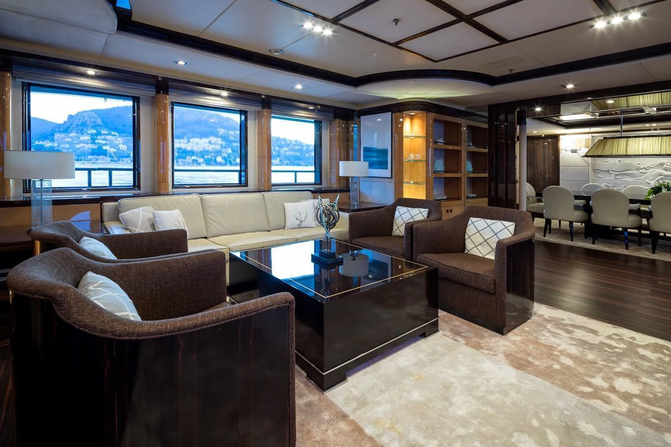 The salon features a luxurious seating area with a modern design and large windows offering scenic views. aboard VISION Yacht for Sale